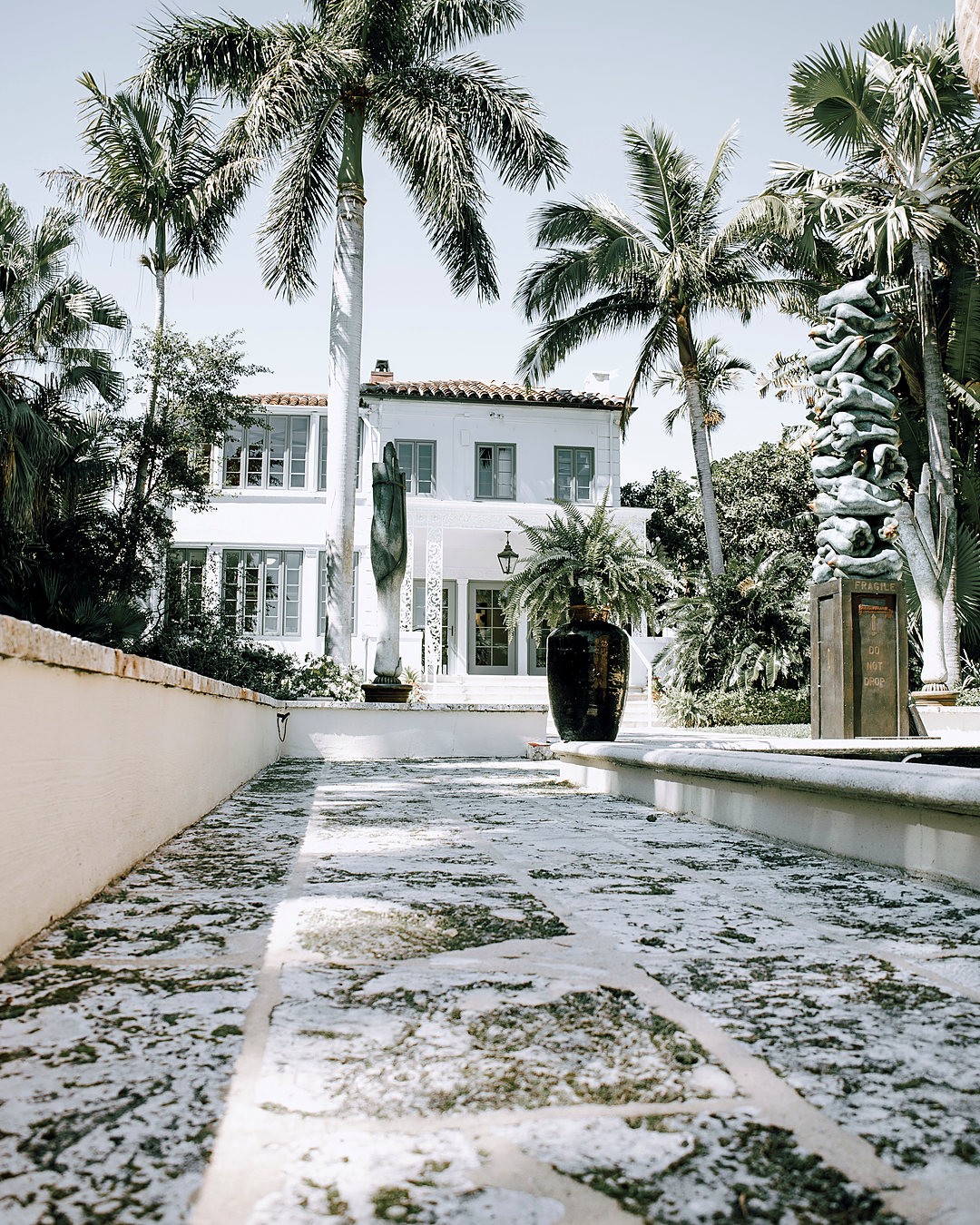White house with royal palms in West Palm Beach